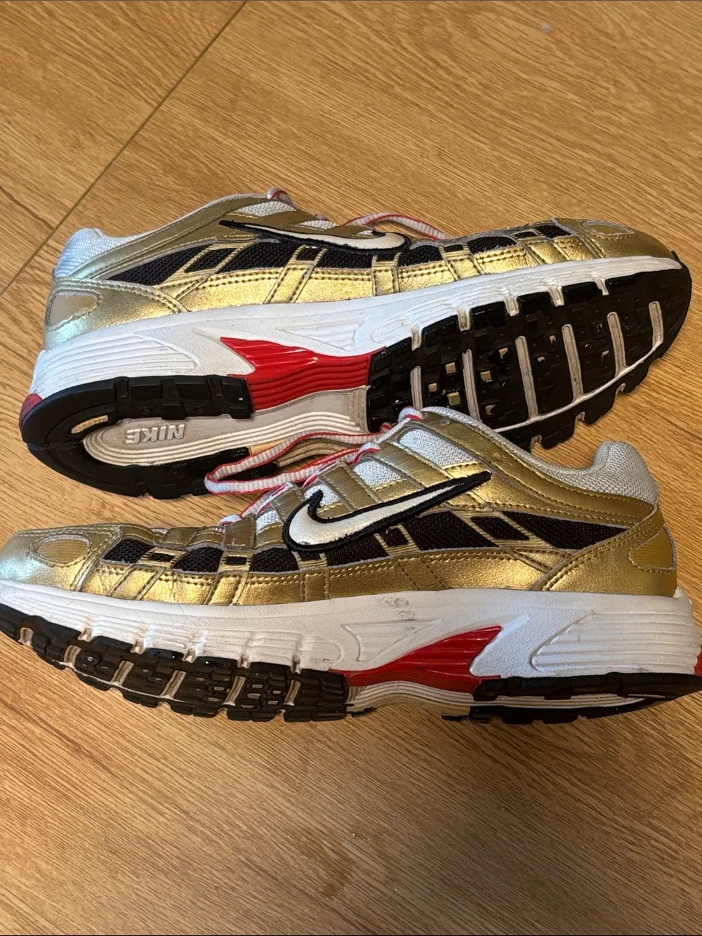 Nike BOWERMAN Metallic Gold, White & Black Athletic Sneakers with Red Details